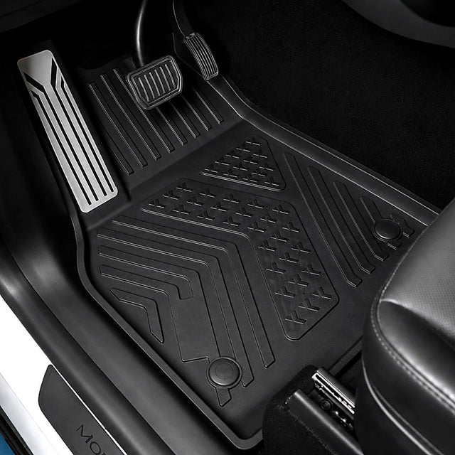 MoldedFit driver floor liner installed in Tesla Model Y Juniper with integrated metal footrest