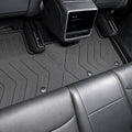 MoldedFit second-row liner installed across the Tesla Model Y Juniper rear footwell
