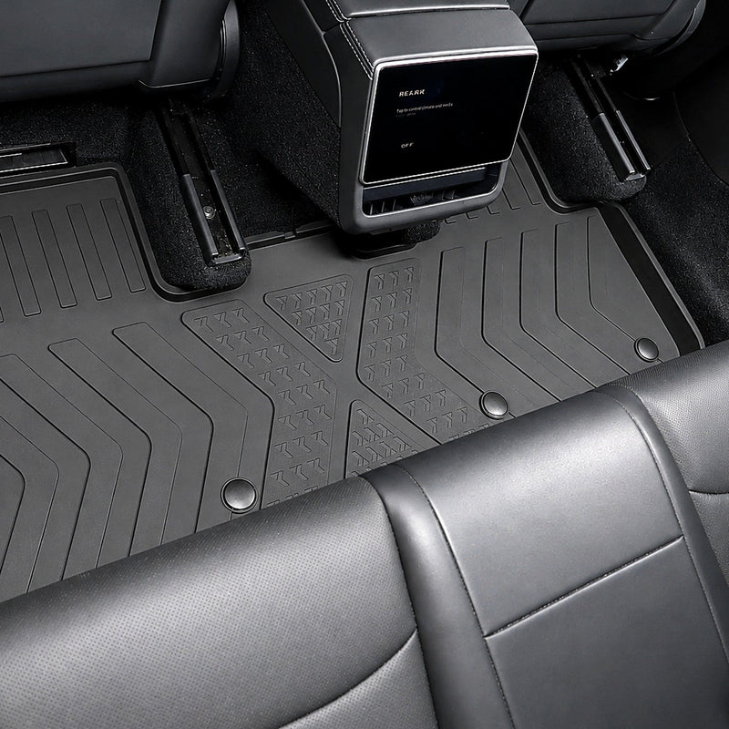 MoldedFit second-row liner installed across the Tesla Model Y Juniper rear footwell